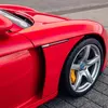 Thumbnail of side profile view of Porsche Carrera GT Rs in Guards Red