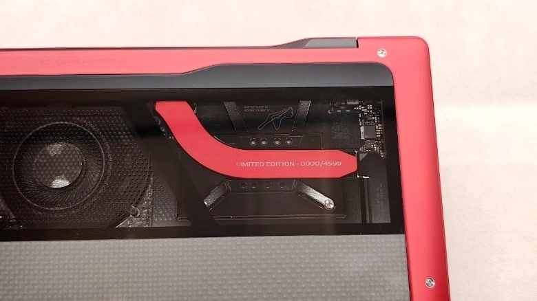The carbon fiber base features a Gorilla Glass panel that exposes the internal cooling system.